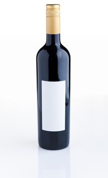 Red wine bottle with empty label over white background