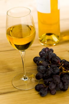 White wine glass with bottle on the table
