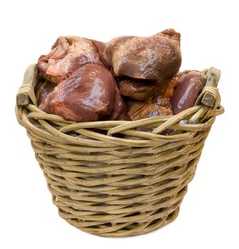 Basket filled with raw swine hearts, isolated on white background.