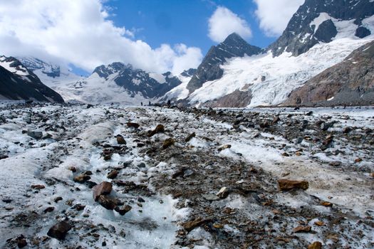 Glacier with rocks and sky with clouds