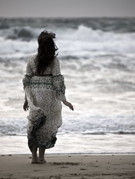 Lone woman walking along a beach in winter
Model: Elaine Saliba