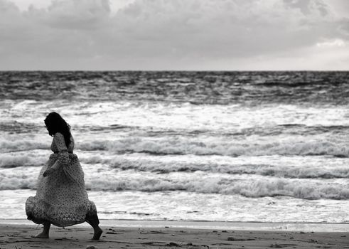 Lone woman walking along a beach in winter
Model: Elaine Saliba