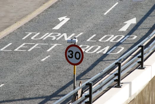 Closeup of empty road showing direction arrows