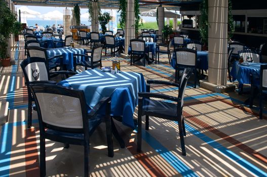 tables with blue table-cloth in open-air restaurant