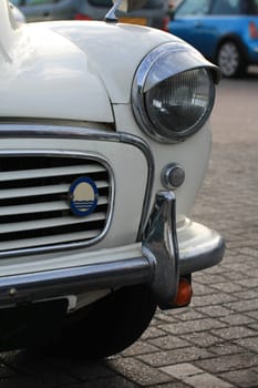 A headlight of a vintage car, made in England