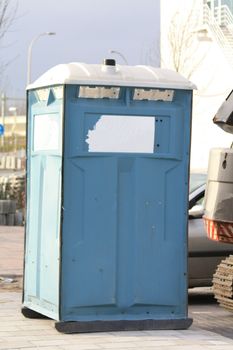 A portable toilet near a construction site