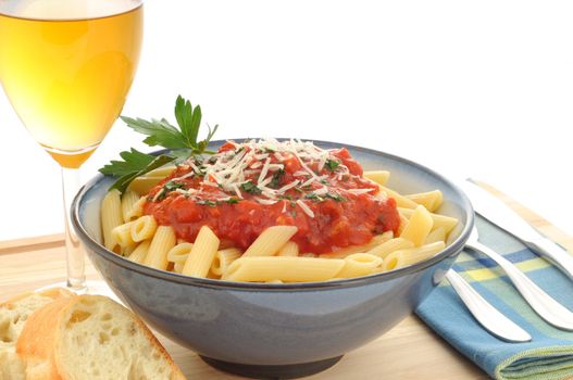 Bowl of delicious penne pasta with white wine.