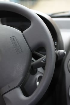 detail of a car interior, steering wheel with airbag