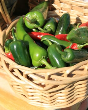 at the farmers market, just picked green peppers in a basket