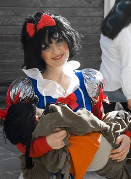 VALLETTA, MALTA - FEB 13 - Woman dressed up as Snow White holding her child at the International Carnival of Malta on Saturday February 13th 2010