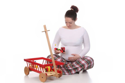 pregnant woman and toys on white background