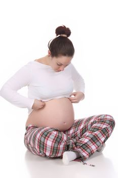 pregnant woman looking belly on white background