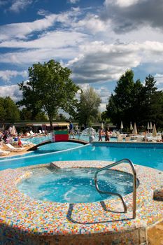 swimming pool at a resort and sky with clouds