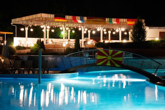 Restaurant near of illuminated pool in resort