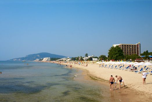 Sand beach with sunshades and hotels in the Bulgaria