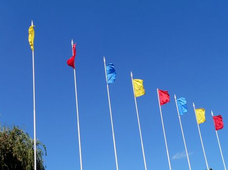 Colored flags on the sky background