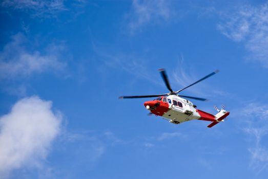 Coastguard helicopter in the blue sky