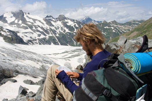 tourist looking to map in high mountains