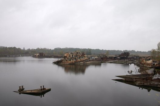 old rusty ships in the river near of Chernobyl