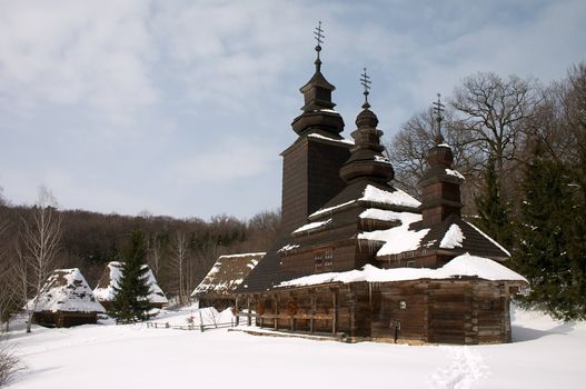 Old wooden church in the snowy countryside lndscape