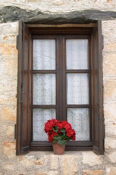 old window with flower pot