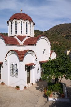 white church with cross on dome under blue sky