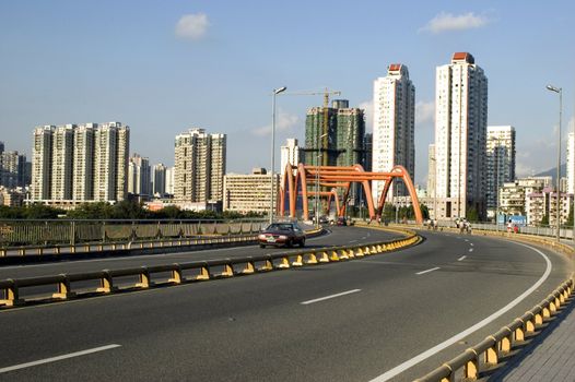 Chinese city - Shenzhen, residential area in Luohu district, high buildings, road and orange bridge. 