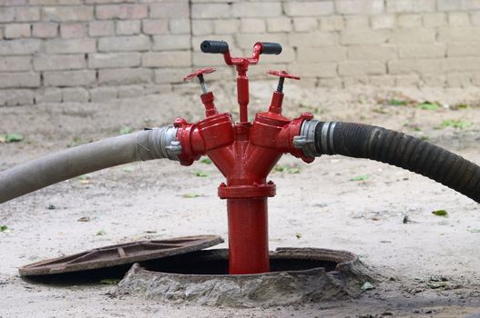 red firecock with connected firehose