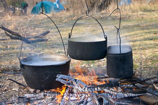 boiled water in kettles above the fire