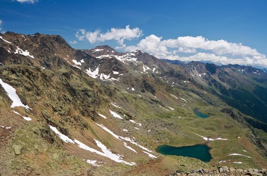 Summer view of Italian alps in Stelvio National park, Trentino, with small lakes and high mountains in a beautiful day. Photo taken with polarized filter