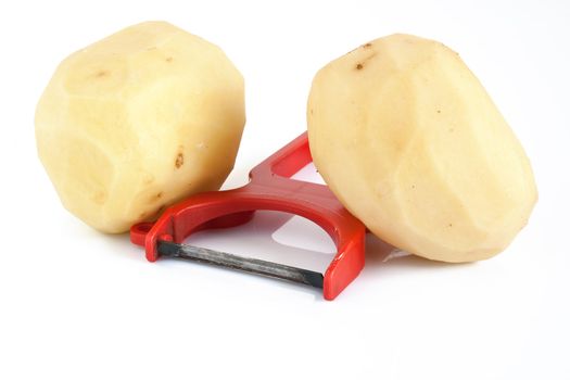 plastic potato pealer and two peeled potatoes isolated on white background