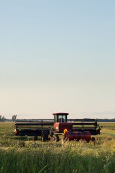 A combine in a field with copyspace available in the sky