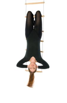 Isolated photo of a woman hanging on a rope ladder
