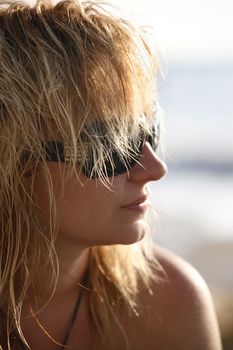 The girl with wet hair in solar glasses