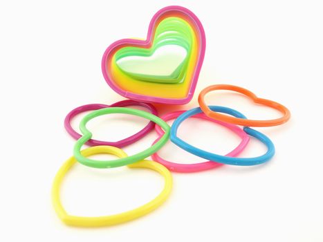 Assortment of colorful hearts and a slinky isolated on a white background
