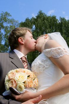 The groom and the bride during walk in park