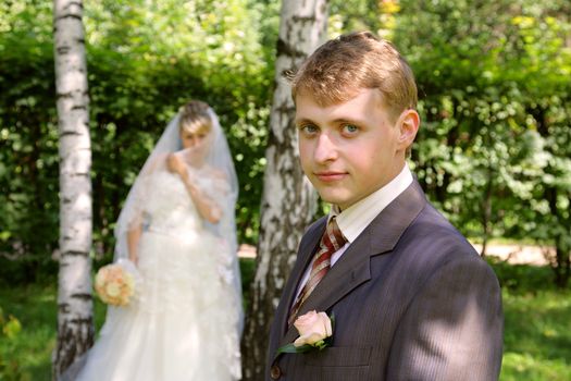 The groom and the bride during walk in park