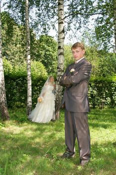 The groom and the bride during walk in park