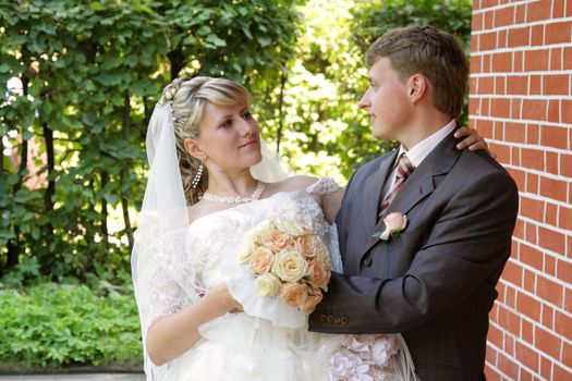 The groom and the bride during walk in park