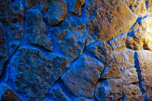 old-style wall of wild stones with decorative lighting