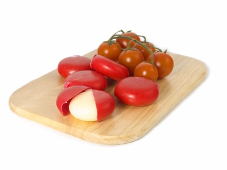 cheese and tomatoes on board isolated on white background