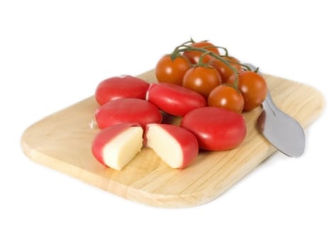 cheese and tomatoes on board isolated on white background