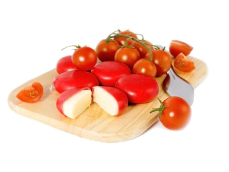 cheese and tomatoes on board isolated on white background