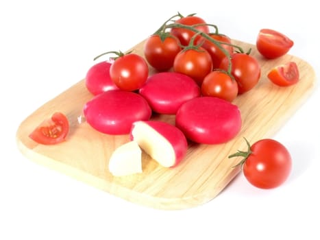 cheese and tomatoes on board isolated on white background