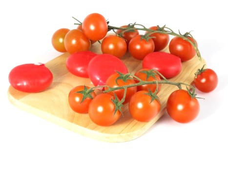 cheese and tomatoes on board isolated on white background