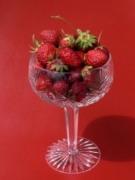 Strawberries in crystal tall wine glass