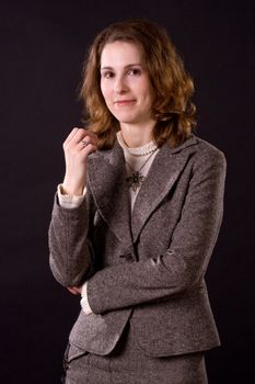 portrait of smiling businesswoman on black
