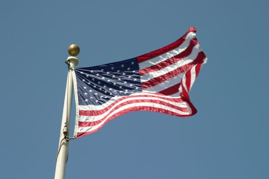 The flag of the United States Of America with the sky in the background