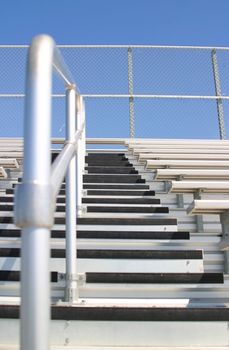 Bleachers in a stadium with the view of some stairs.