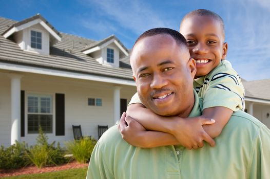 Happy African American Father and Son Outside of their Home.